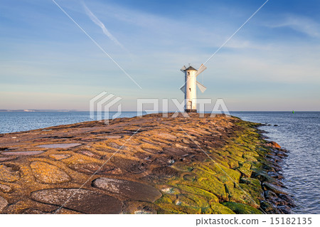 Vivid sunrise over pier and lighthouse. Vivid sunrise over pier and lighthouse. 15182135