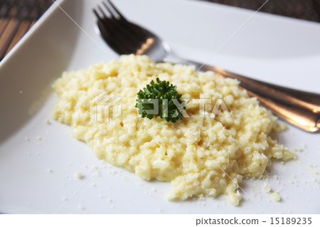 risotto dish with herbs on wood background risotto dish with herbs on wood background 15189235