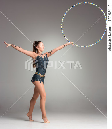 teenager doing gymnastics exercises with colorful hoop teenager doing gymnastics exercises with colorful hoop 15198441
