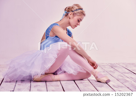 Professional ballerina putting on her ballet shoes. 15202367