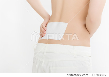 A young woman suffering from low back pain A young woman suffering from low back pain 15203307