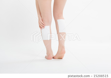 A woman putting a poultice medicine on her foot 15208515