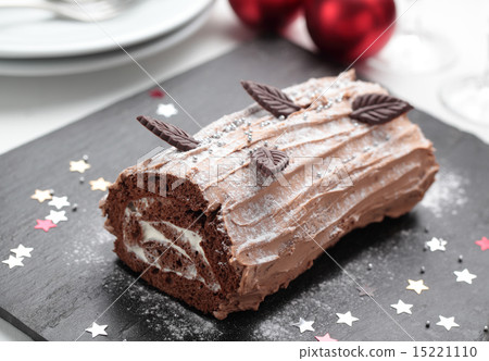 Yule log cake on a Christmas table 15221110
