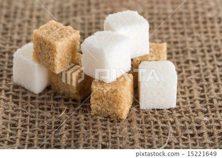 cubes of brown and white sugar on jute bags 15221649