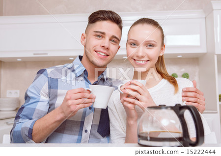 Young couple sitting and drinking coffee Young couple sitting and drinking coffee 15222444