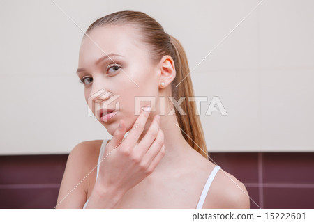 Pretty young woman looking in mirror Pretty young woman looking in mirror 15222601