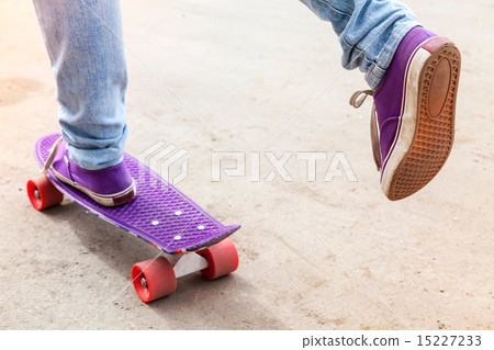 Feet of riding skateboarder in jeans and gumshoes Feet of riding skateboarder in jeans and gumshoes 15227233