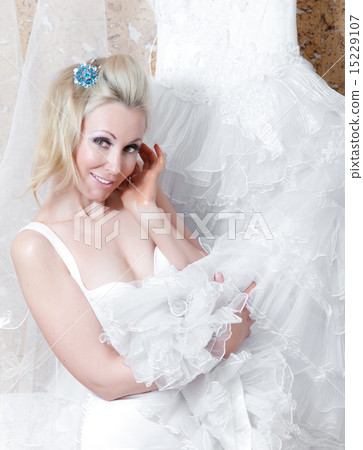 woman near to a wedding dress dreams of wedding 15229107