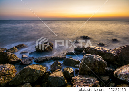 Beautiful sunset on beach with crashing waves Beautiful sunset on beach with crashing waves 15229413