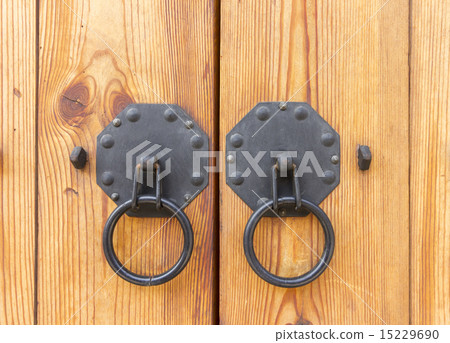 Vintage wooden gate with two door knocker closeup 15229690