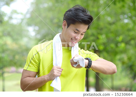 Young Chinese man checking his run duration 15230664