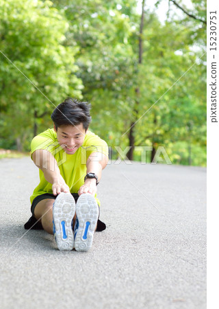 Young Chinese man warming up for exercise Young Chinese man warming up for exercise 15230751