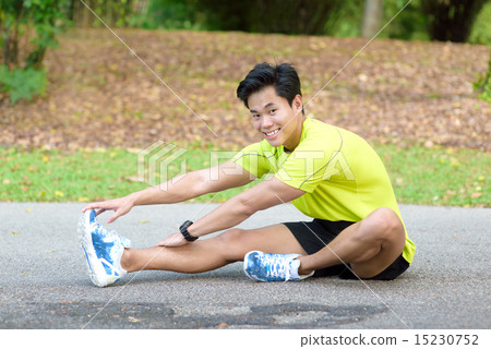 Young Chinese man warming up for exercise Young Chinese man warming up for exercise 15230752