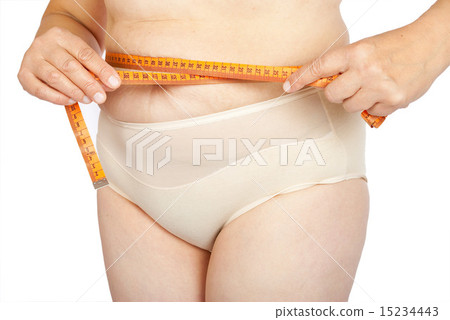 Fat woman measuring her stomach Fat woman measuring her stomach 15234443