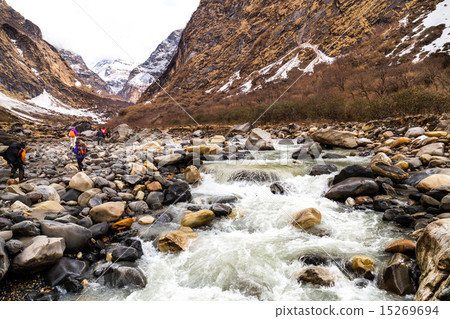 Group of people hiking through a snowy valley Group of people hiking through a snowy valley 15269694