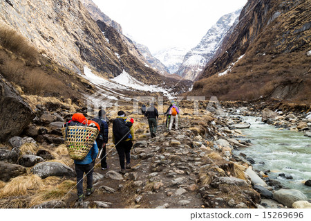A group of people hiking towards serene mountain A group of people hiking towards serene mountain 15269696