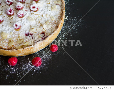 Mascarpone pie with fresh raspberries, almond and sugar powder o 15273607