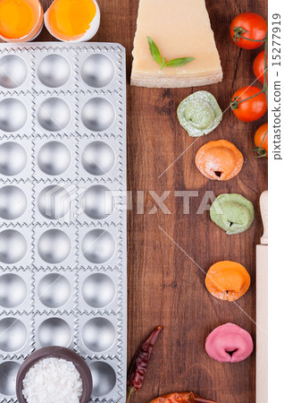 Multicolored ravioli on a wooden board 15277919