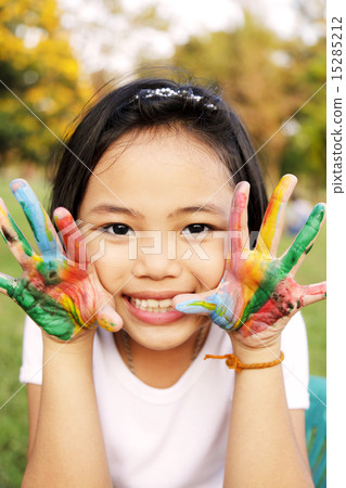 Little girl with hands painted in colorful paint 15285212