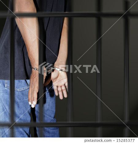 Prisoner locked in handcuffs 15285377