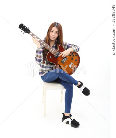 Woman playing guitar Woman playing guitar 15288349