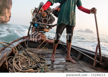 Thai man driving a long-tail boat in Thailand 15294213