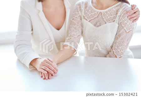 close up of happy married lesbian couple hugging close up of happy married lesbian couple hugging 15302421