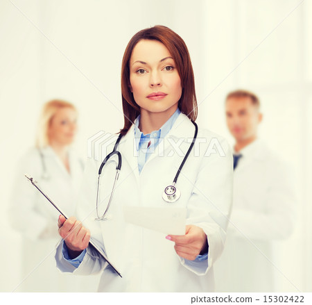 calm female doctor with clipboard calm female doctor with clipboard 15302422