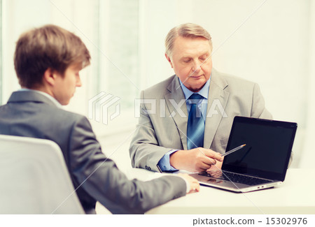 older man and young man with laptop computer older man and young man with laptop computer 15302976