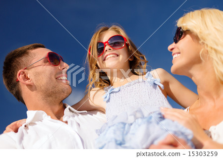 happy family in sunglasses over blue sky happy family in sunglasses over blue sky 15303259