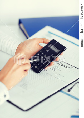 woman hand with calculator and papers woman hand with calculator and papers 15303667