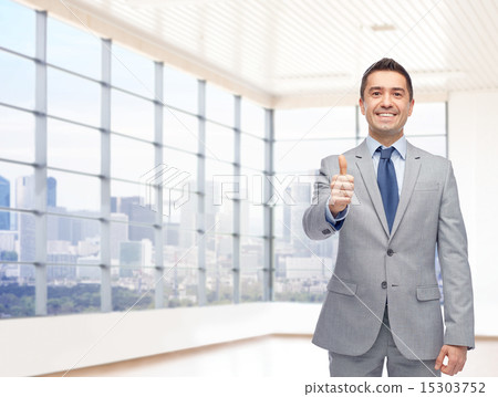 happy businessman in suit showing thumbs up 15303752