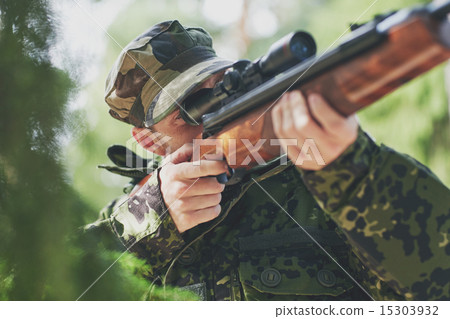 soldier or hunter shooting with gun in forest soldier or hunter shooting with gun in forest 15303932