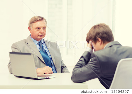 older man and young man having argument in office 15304297