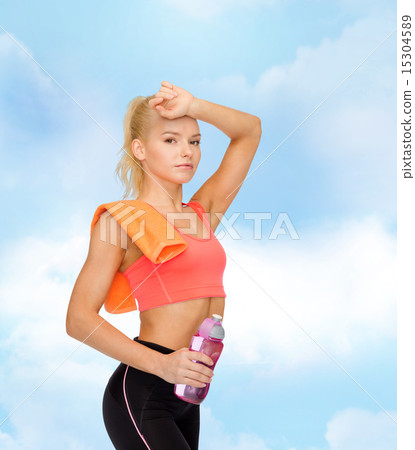 tired sporty woman with towel and water bottle 15304589