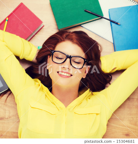 smiling student in eyeglasses lying on floor smiling student in eyeglasses lying on floor 15304681