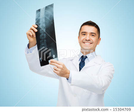 smiling male doctor in white coat holding x-ray smiling male doctor in white coat holding x-ray 15304709