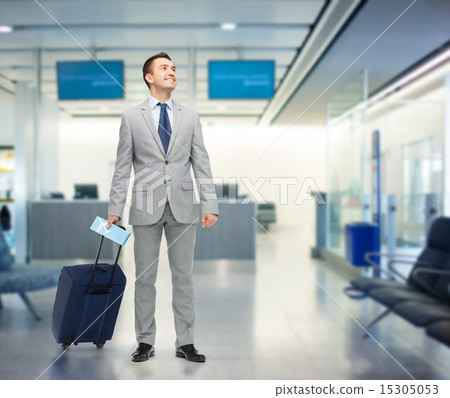 Stock Photo: happy businessman in suit with travel bag