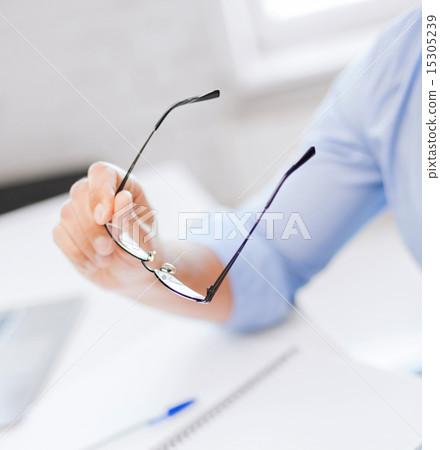 businessman holding glasses businessman holding glasses 15305239