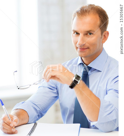 businessman with spectacles writing in notebook businessman with spectacles writing in notebook 15305667