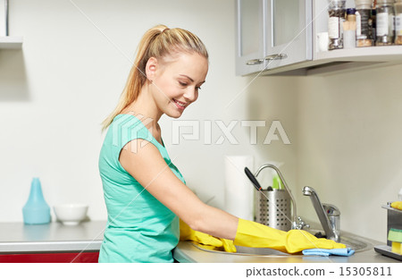 happy woman cleaning table at home kitchen 15305811