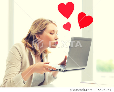 woman sending kisses with laptop computer 15306065