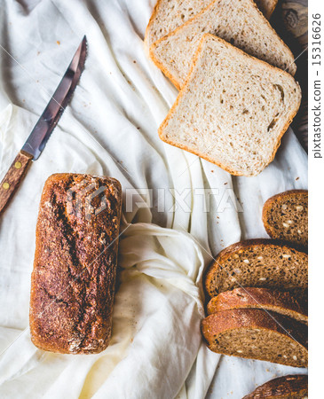 bread, slices of rye bread on linen tablecloths 15316626