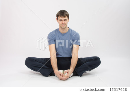 Athlete sitting holding hands your feet Athlete sitting holding hands your feet 15317628