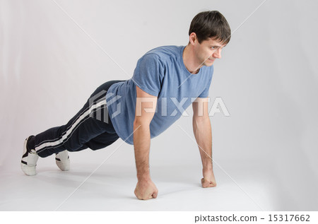 Young guy pushed off the floor with their fists Young guy pushed off the floor with their fists 15317662
