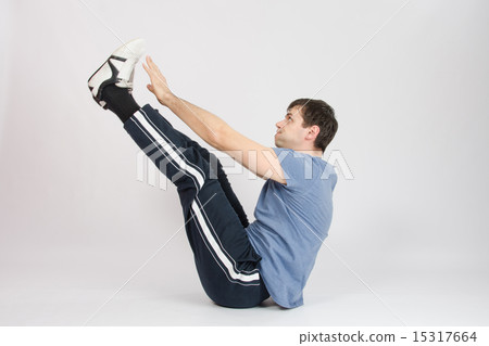 Athlete stretching his arms raised to the feet Athlete stretching his arms raised to the feet 15317664