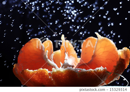 peeled tangerines on black background 15329314