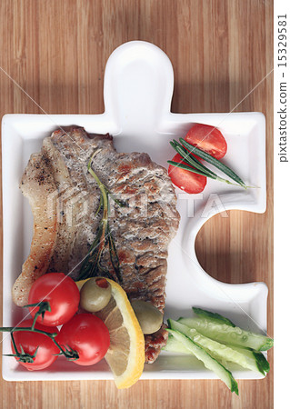meat in an unusual serving plate 15329581