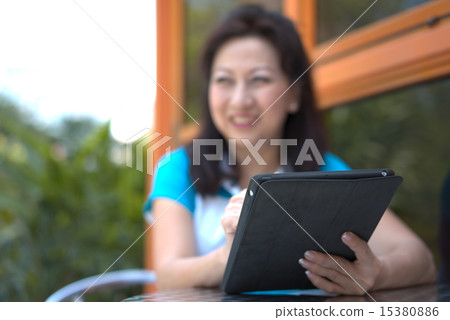 Middle age woman using a smart wireless device. 15380886