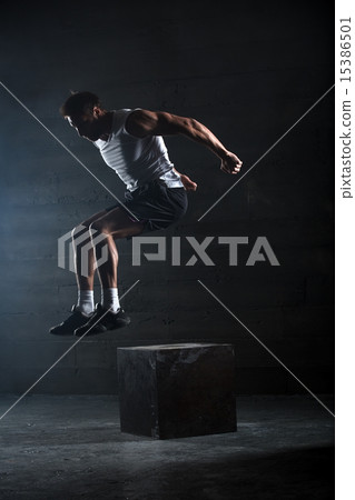 Athlete gave exercise. Jumping on the box. Phase touchdown.  15386501